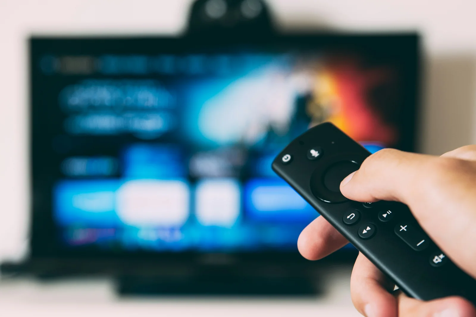 A TV remote ready to choose a player on a smart television